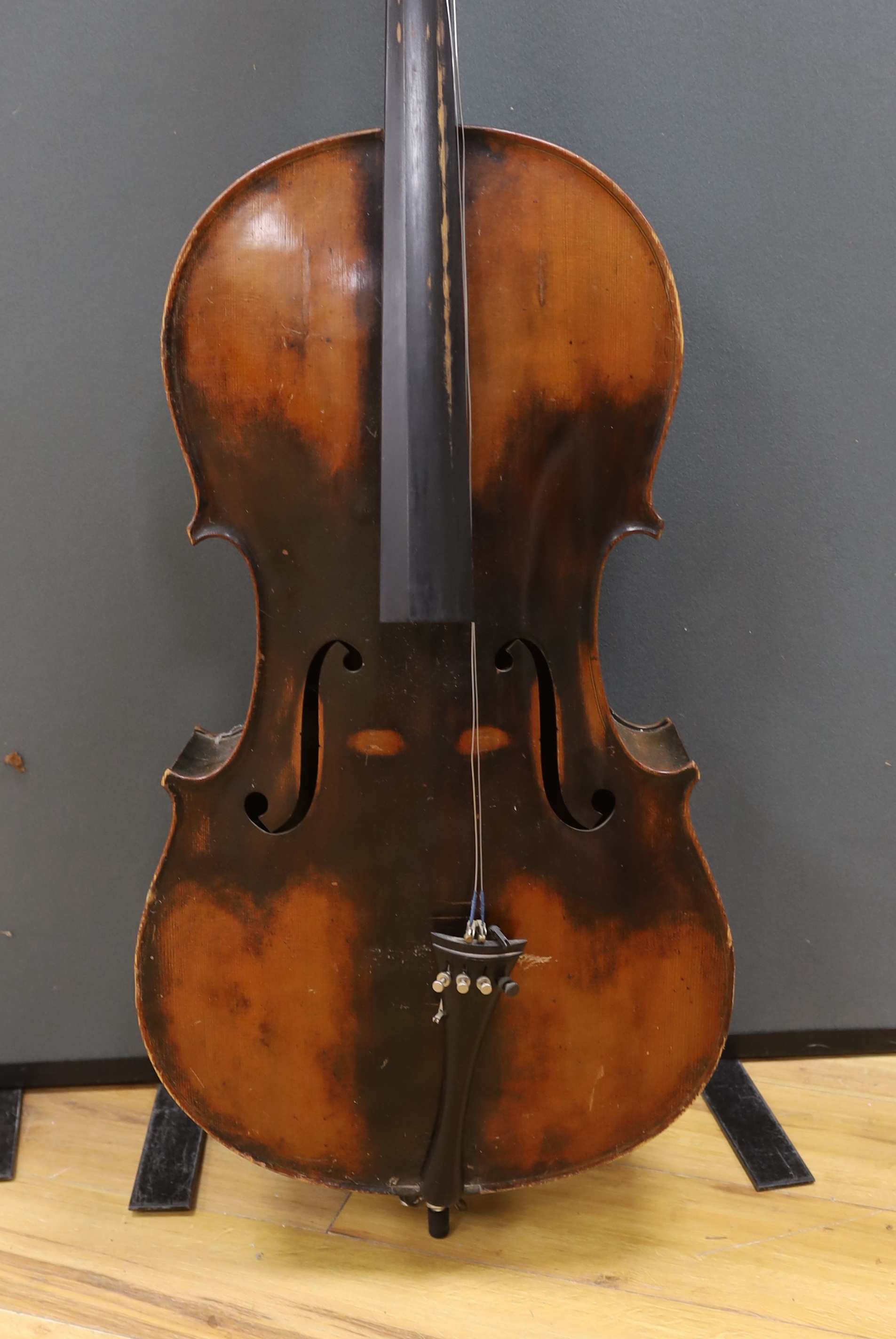 A full size cello labelled Adolf Stowaller, cased, 132cm high